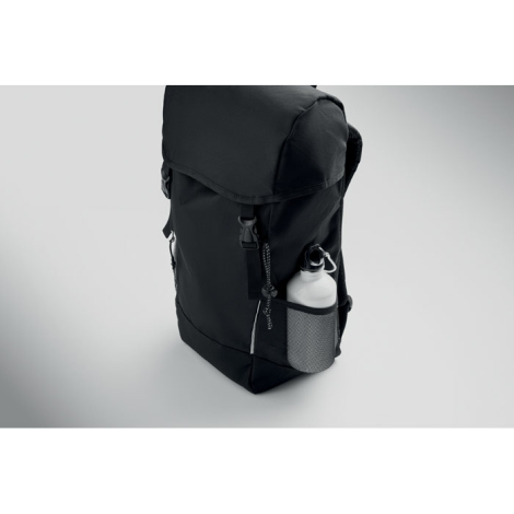 Sac à dos noir vu de trois quarts, avec une bouteille placée dans l’une des poches latérales en filet.