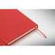 Gros plan sur un cahier rouge fermé avec ruban marque-page, montrant un symbole et une inscription en relief dans l’angle inféri Gros plan sur un cahier rouge fermé avec ruban marque-page, montrant un symbole et une inscription en relief dans l’angle inféri