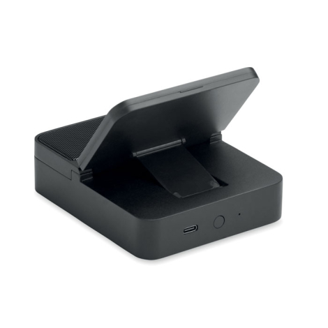Vue arrière du haut-parleur noir avec support pour smartphone relevé, béquille déployée, port USB-C et bouton rond visibles.