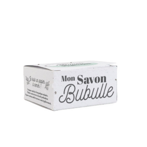 Gros plan sur une boîte en papier ensemencé « Mon Savon Bubulle », avec inscriptions et illustrations végétales, sur fond blanc.