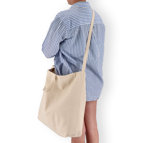 Sac cabas beige porté à l’épaule, sans marquage visible
