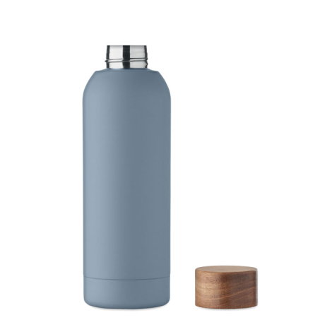 Bouteille bleue ouverte montrant l’intérieur en acier, bouchon en bois à côté.