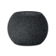 Enceinte sans fil ronde en tissu noir, surface supérieure lisse avec commandes intégrées, marquage visible sur le dessus.