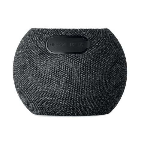 Vue arrière d’une enceinte sans fil ronde noire montrant l’interrupteur et le port de charge.