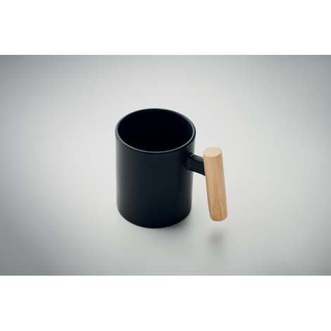 Mug en céramique noir avec anse en bois clair, vue en plongée.