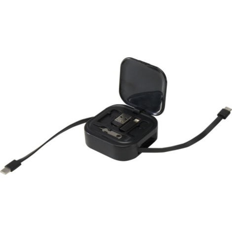 Boîtier carré noir ouvert montrant les embouts de connexion et accessoires internes, aucun marquage visible.