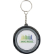 Porte-clés gyroscope rond vu de face, surface centrale blanche avec marquage visible sur la zone centrale. Porte-clés gyroscope rond vu de face, surface centrale blanche avec marquage visible sur la zone centrale.