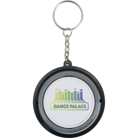 Porte-clés gyroscope rond vu de face, surface centrale blanche avec marquage visible sur la zone centrale. Porte-clés gyroscope rond vu de face, surface centrale blanche avec marquage visible sur la zone centrale.
