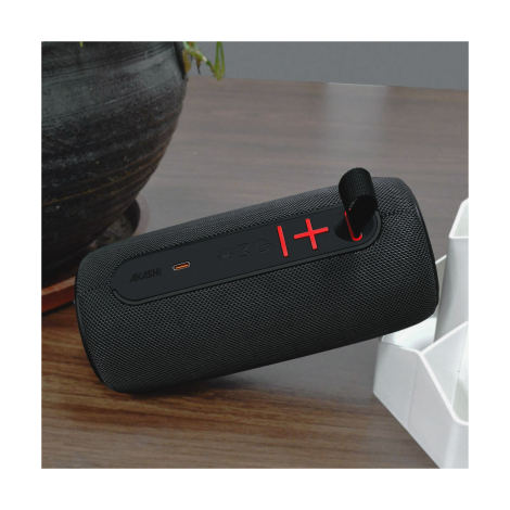 Enceinte noire sur table intérieure avec sangle textile