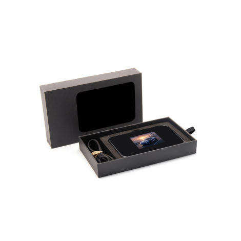 Coffret de présentation rectangulaire ouvert sur fond blanc, powerbank positionnée à l’intérieur avec câble rangé, écran visible