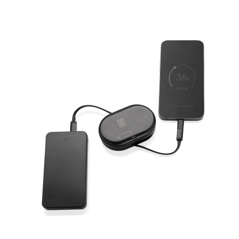 Boîtier de recharge noir fermé à plat sur fond blanc, relié par câble à une batterie externe et à un smartphone en charge, aucun