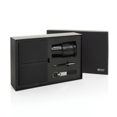 Coffret cadeau ouvert sur fond blanc avec mug, carnet, stylo et porte-clés disposés dans des logements en mousse noire, marquage