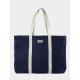 Sac cabas bleu marine vu de face avec étiquette centrale personnalisée. Sac cabas bleu marine vu de face avec étiquette centrale personnalisée.
