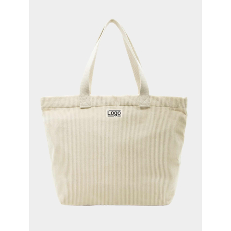 Sac cabas beige clair présenté de face avec anses ton sur ton et étiquette centrale personnalisée.