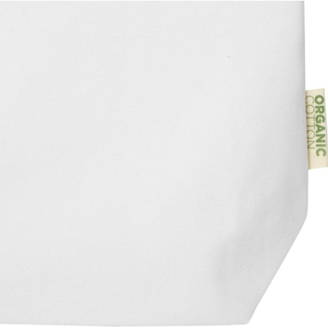 Gros plan sur la partie inférieure d’un sac écru avec étiquette textile latérale indiquant la composition, sans personnalisation