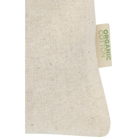 Gros plan sur la matière du sac écru mettant en évidence le tissage du coton et une étiquette textile latérale, sans marquage ap