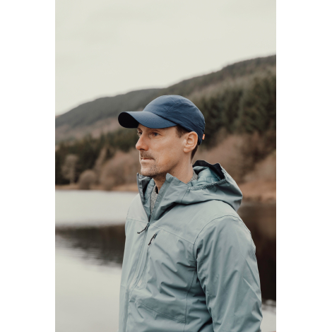 Casquette bleue portée par un homme en extérieur sans personnalisation visible