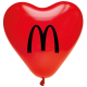 Ballon gonflable rouge en forme de cœur, vue de face, présentant une personnalisation visible au centre.